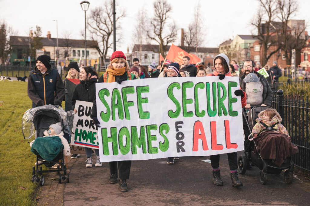 CATU Belfast Protest carrying a sign that reads Safe Secure Homes for All